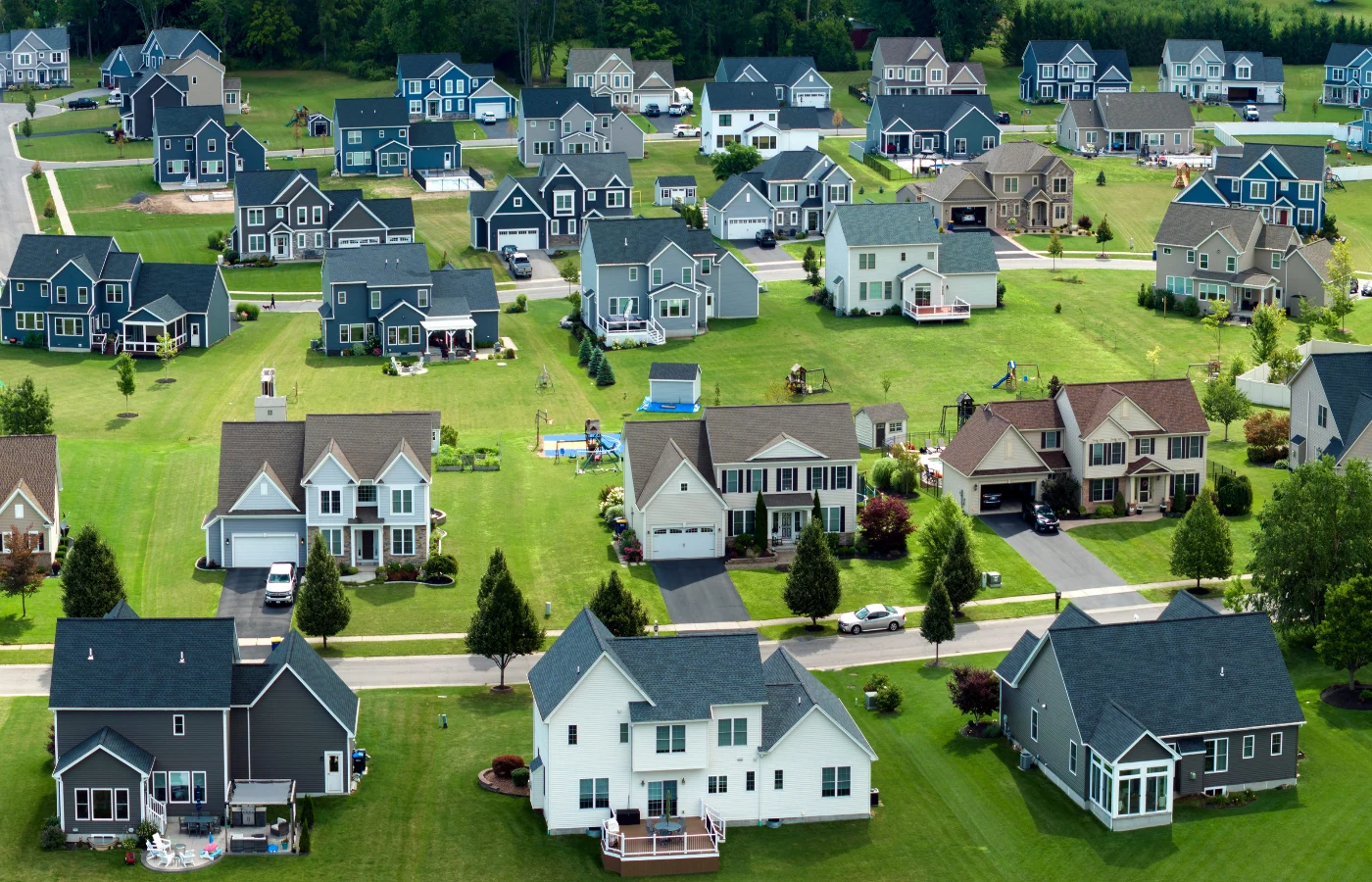 Rows of new two-story homes in a subdivision, seen from above