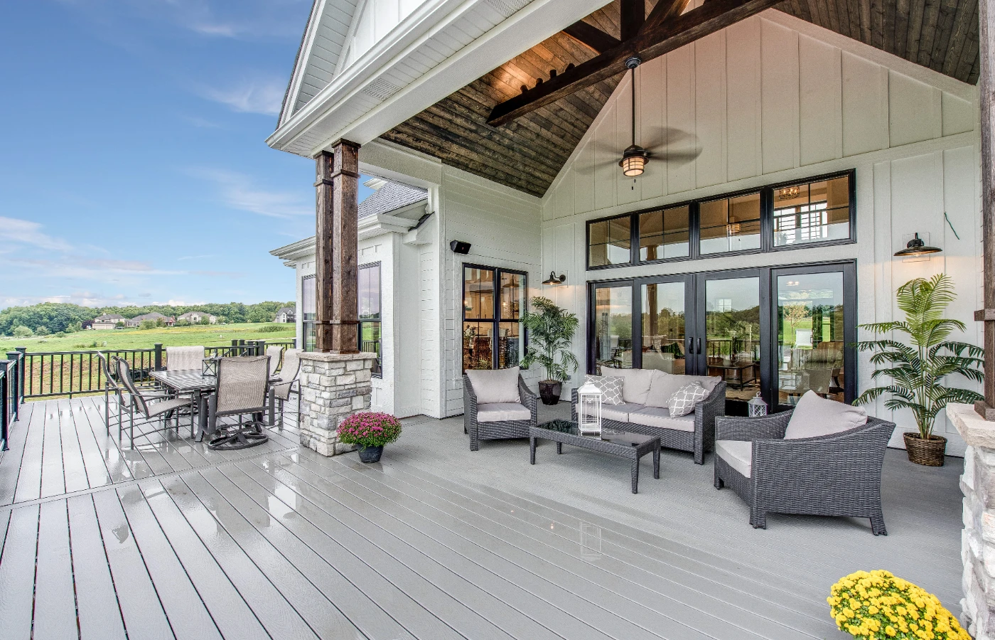 Covered back porch with outdoor seating and a ceiling fan