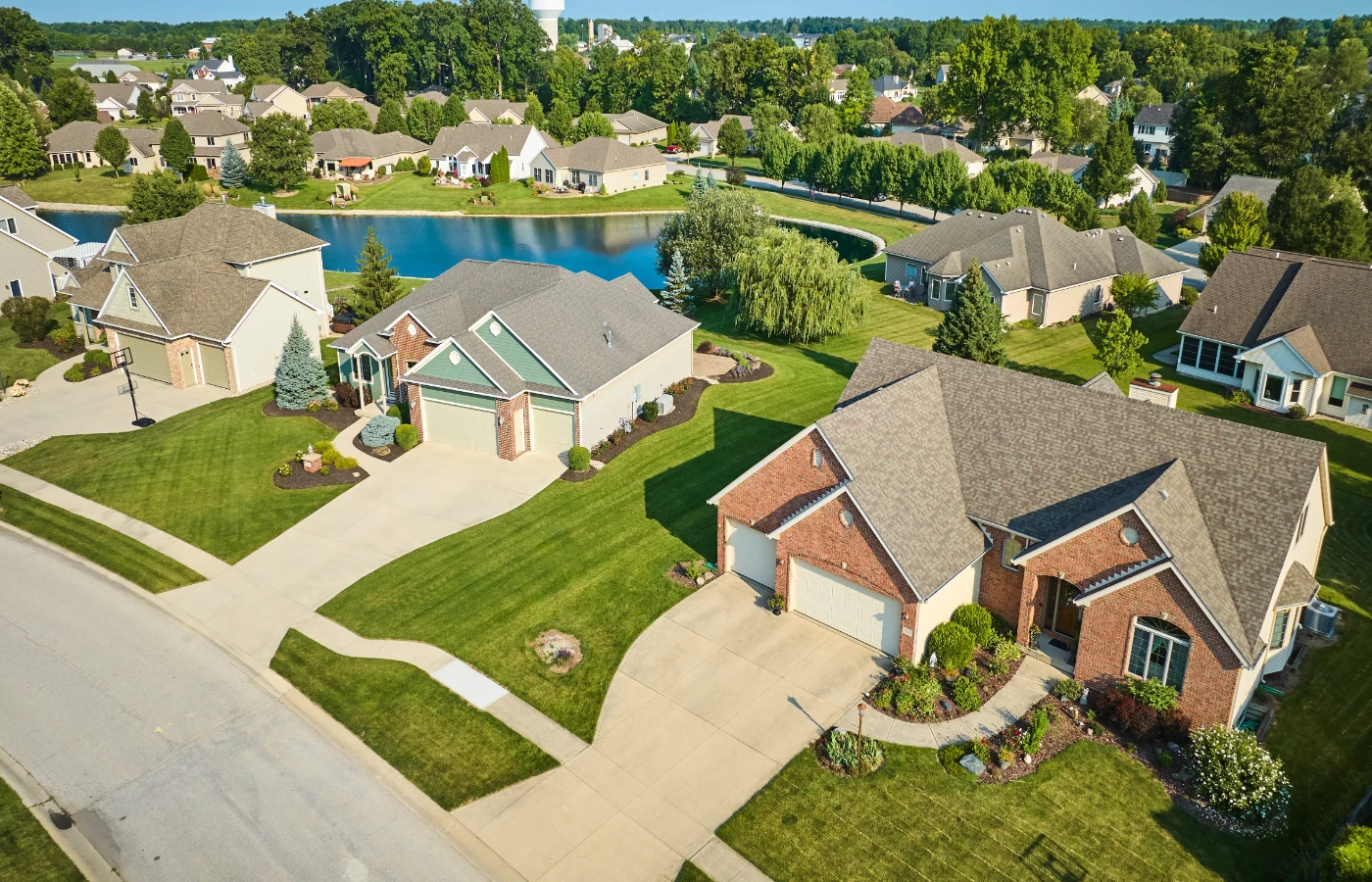 Brick homes around a pond on curving subdivision streets